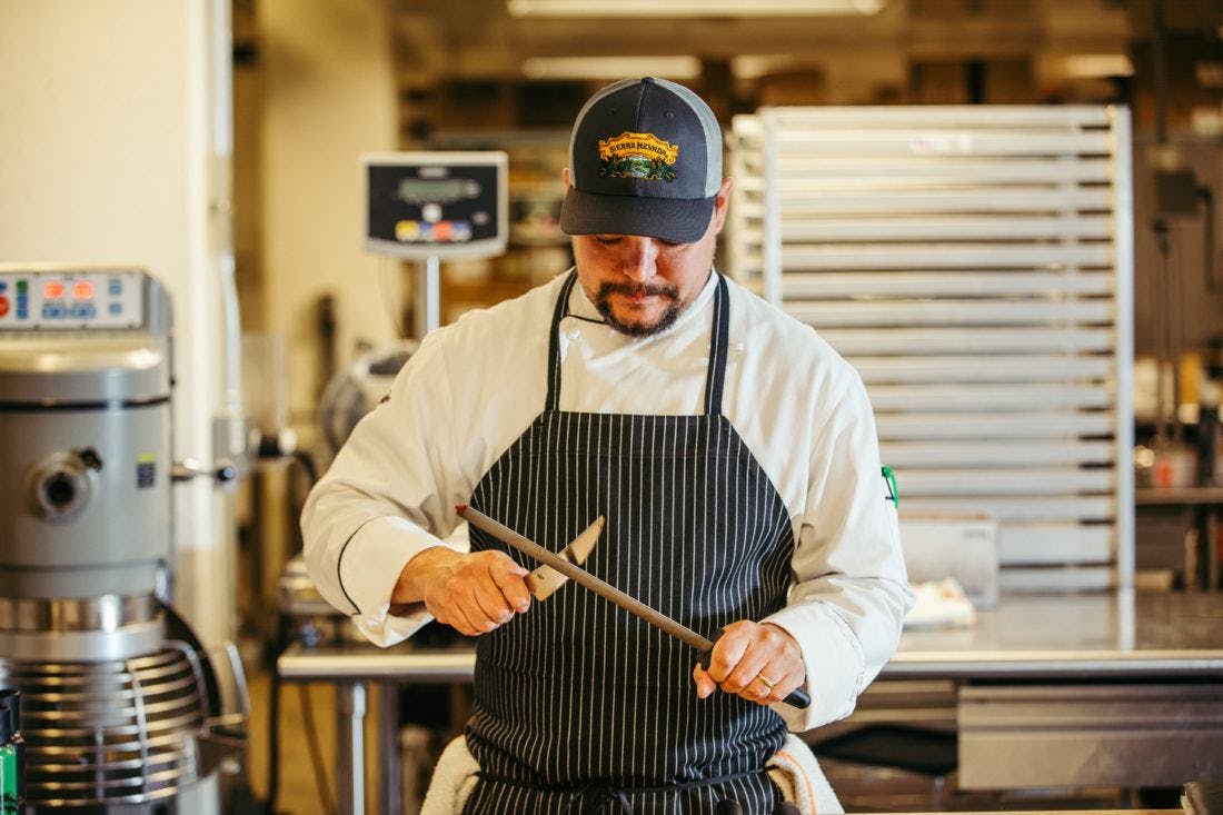 a cook sharpening a knife