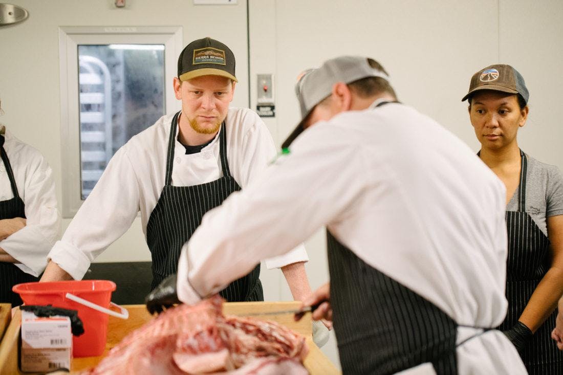 cooks cutting meat