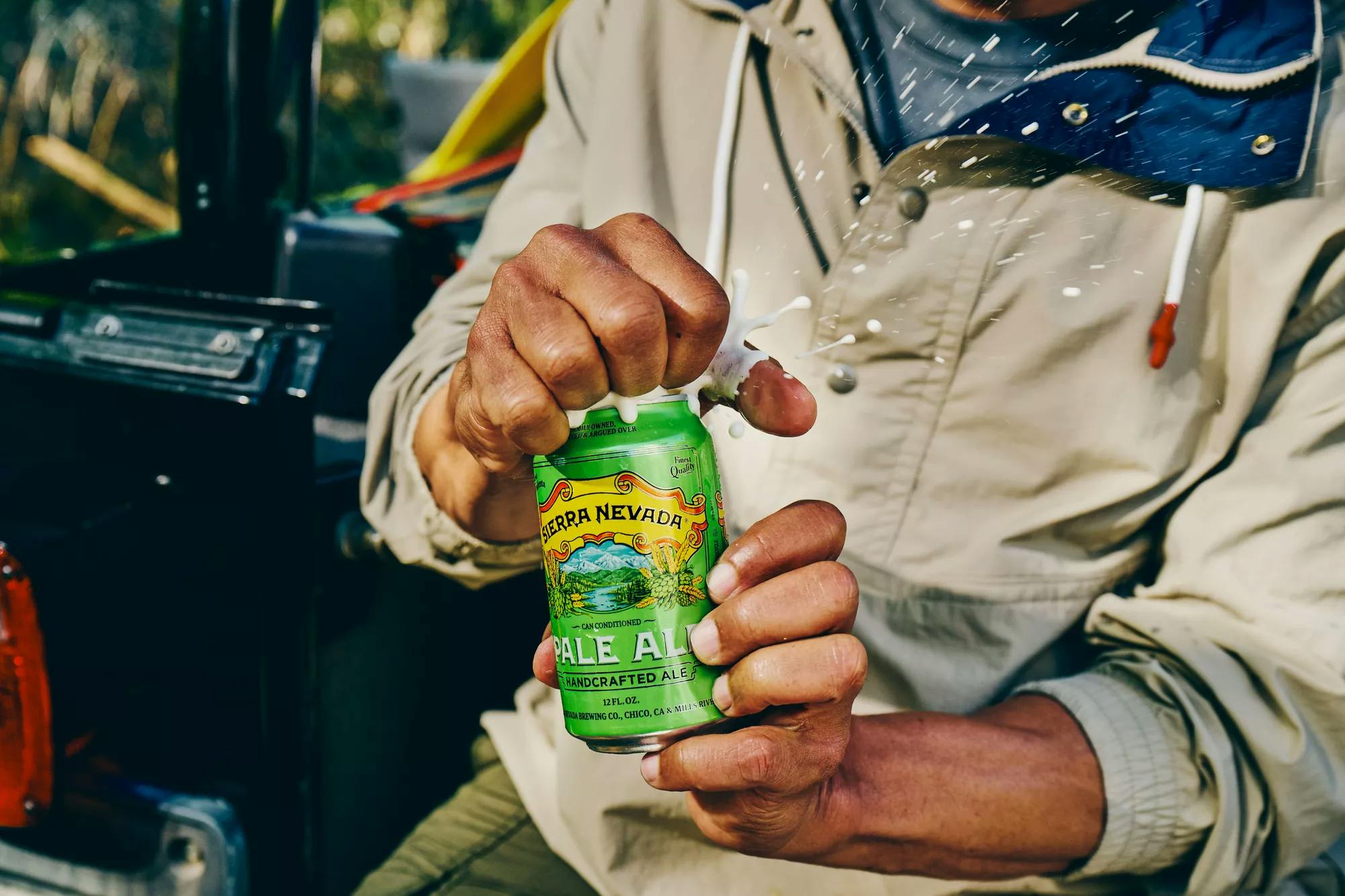 Person opening can of Pale Ale outside