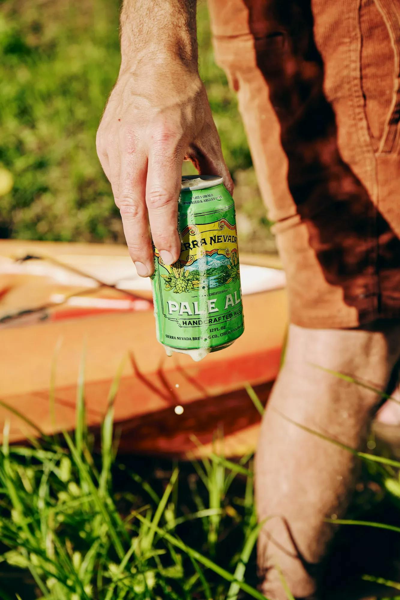 Person carrying can of Pale Ale while outside