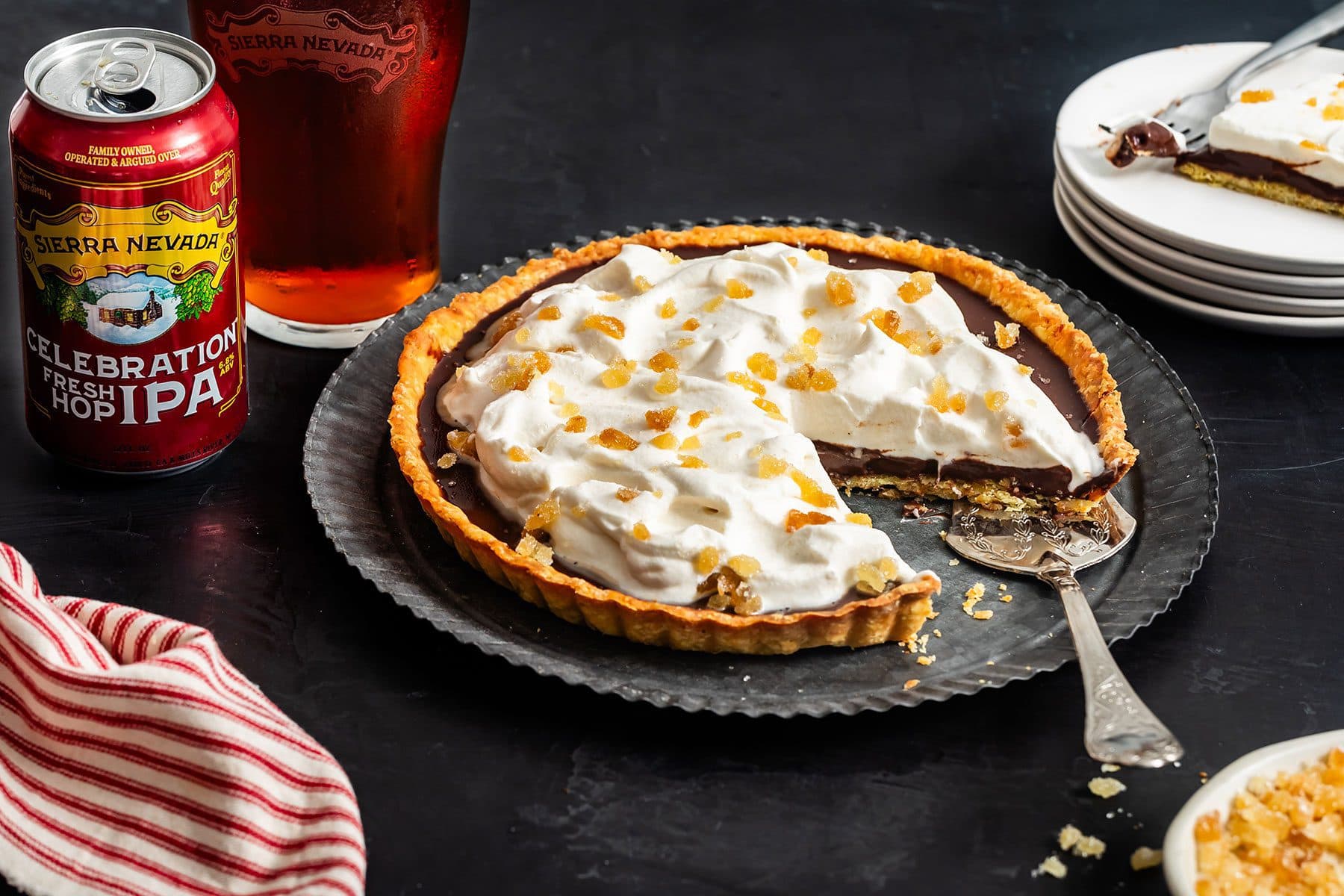 A chocolate tart pie next to a can and glass of Celebration IPA